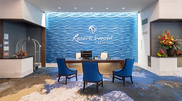 Concierge desk and area with blue chairs and a desk located next to hotel check in to assist with all of your needs for your stay.