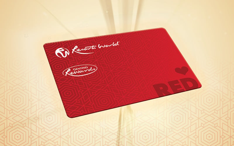 A red Resorts World membership card featuring the company’s logo and decorative patterns, set against a light background with subtle geometric designs.