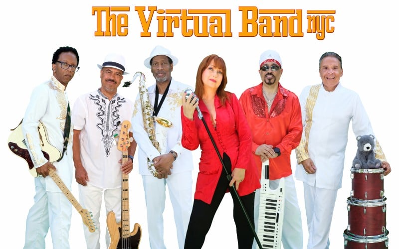 Members of The Virtual Band Nyc. 6 people standing next to each other with instruments.