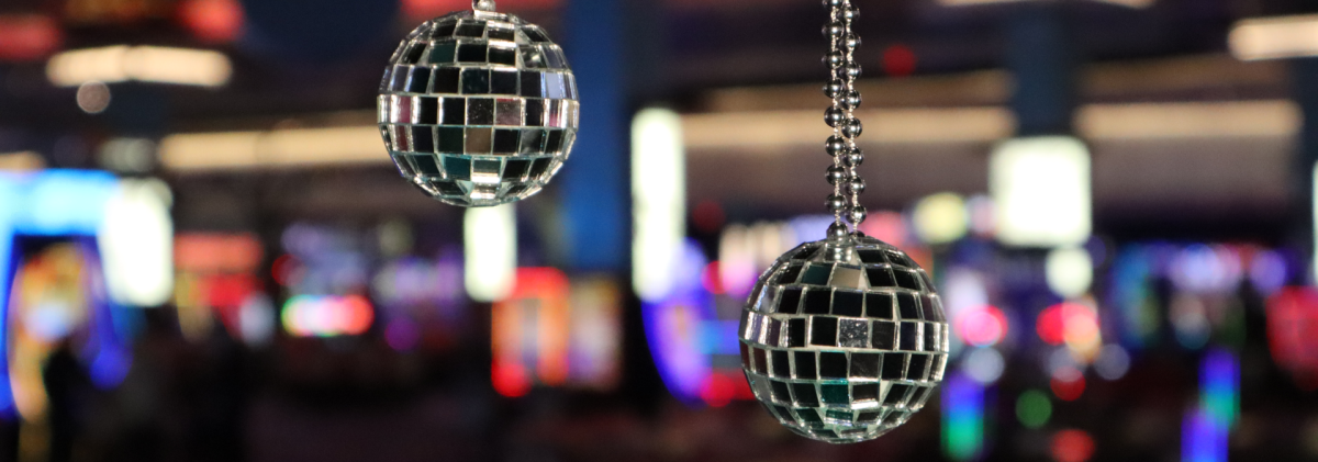 2 Disco Balls in front of a blurred casino floor